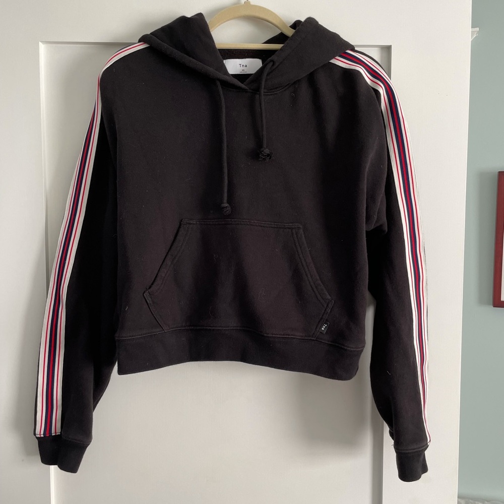 Aritzia “TNA” brand black cropped hoodie with stripes down each sleeve.  XS.